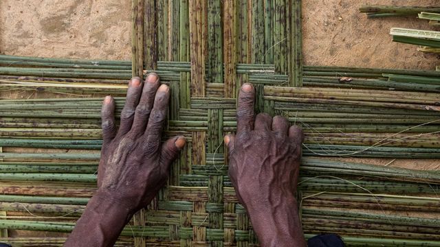 Hands over a wicker weave